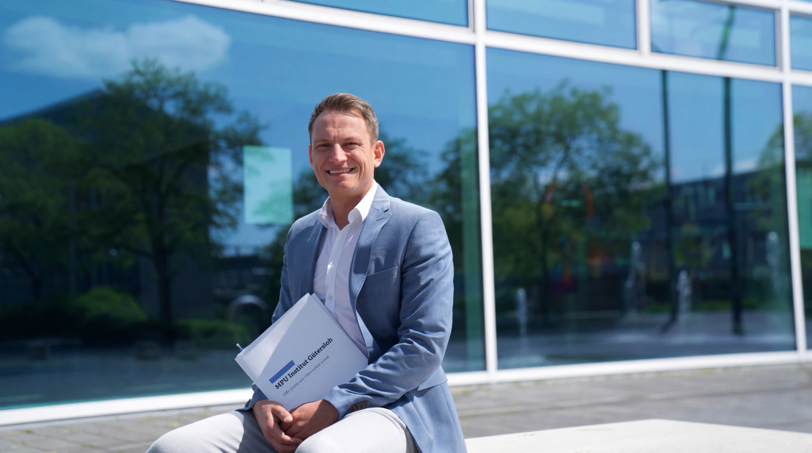 Dawid Trelka mit einer Mappe des MPU Instituts Gütersloh